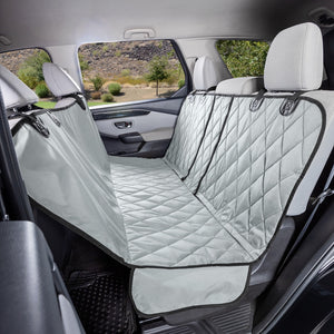 Grey quilted fabric hammock seat cover with black trim installed in the rear of a vehicle.